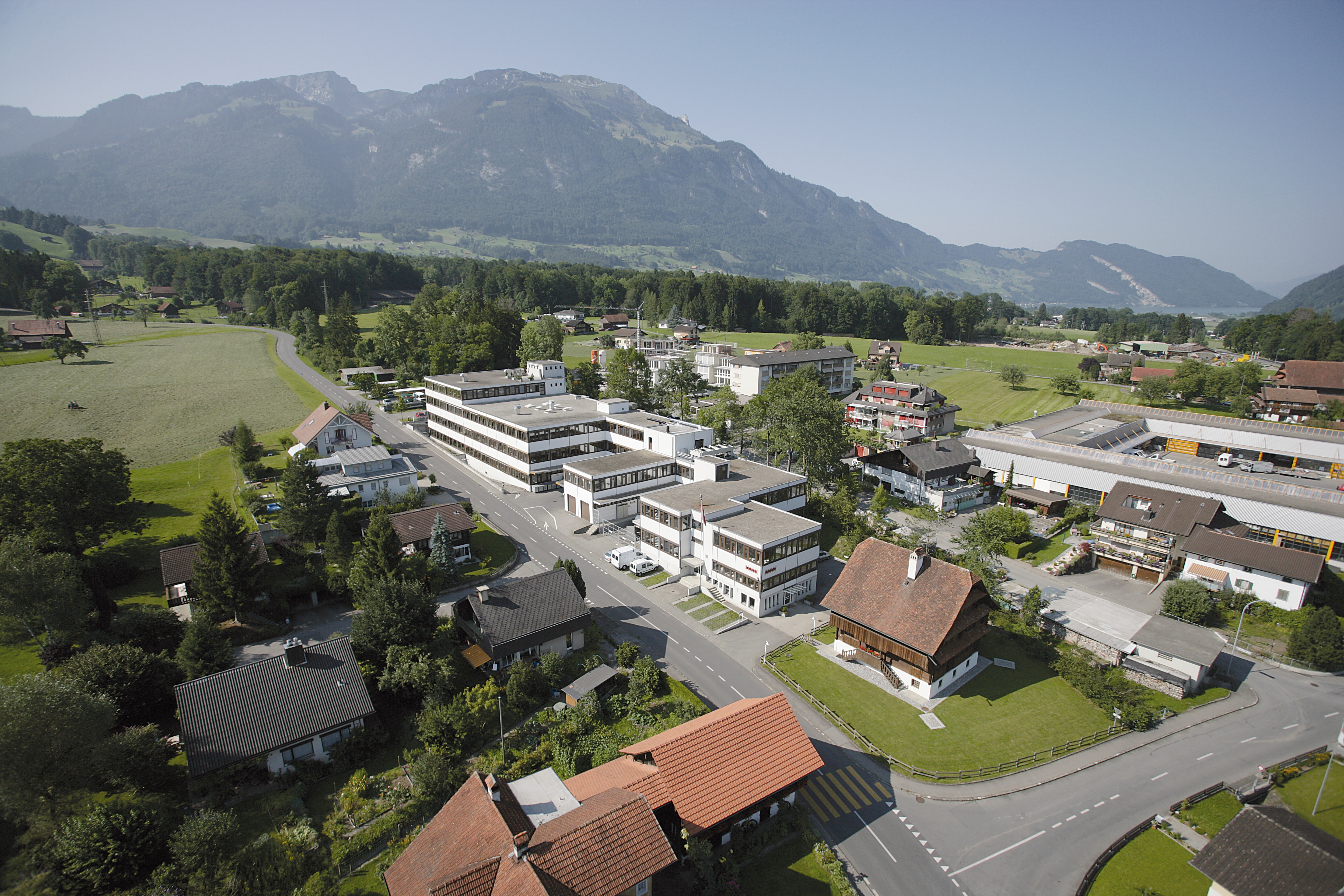 Modern Leister Group headquarters and production building in Kaegiswil, Switzerland, set against scenic mountains—showcasing global innovation and Swiss quality.
