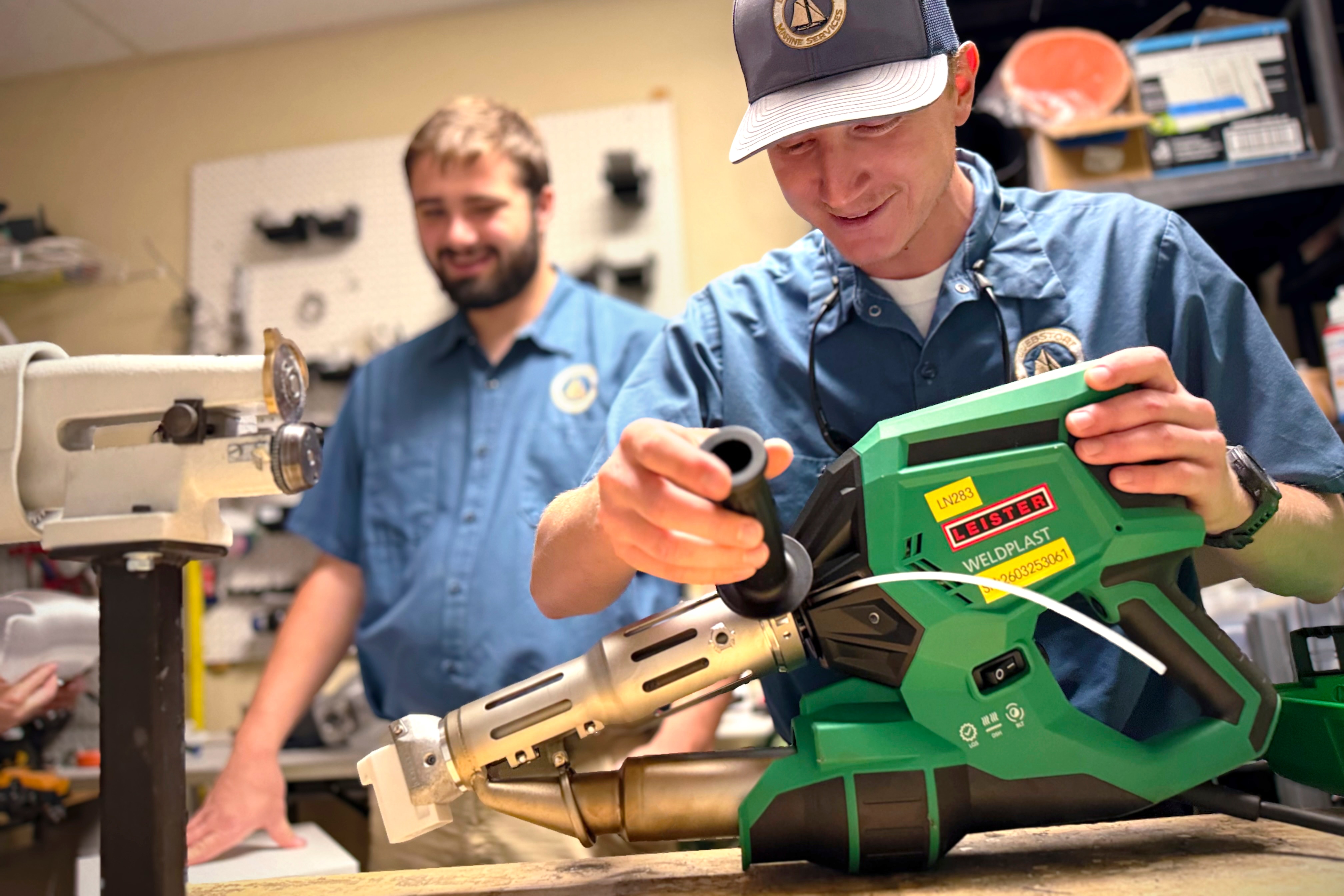 Participants practising welding with Leister equipment during training.