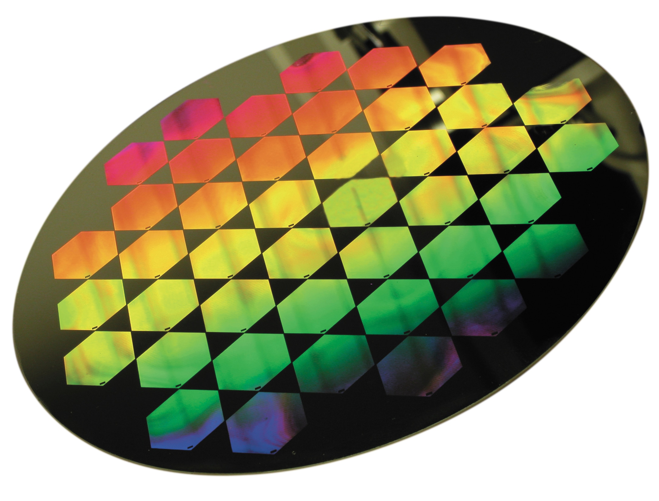 Semiconductor wafer with patterned photonic or optoelectronic microstructures, exhibiting iridescent colors from surface features.